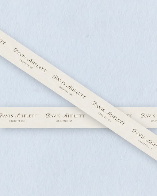 Ribbon printed with the Davis Shiflett Creative Co. logo on pale blue paper